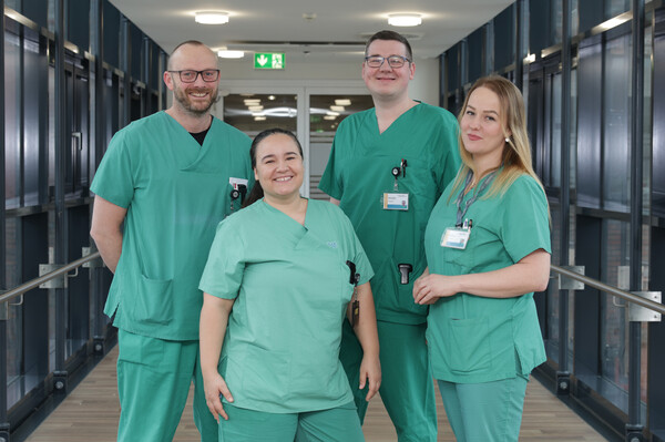 Vier leitende Pflegekräfte vor der Stationstür