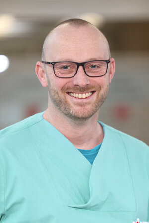 Portraitfoto in grüner Dienstkleidung